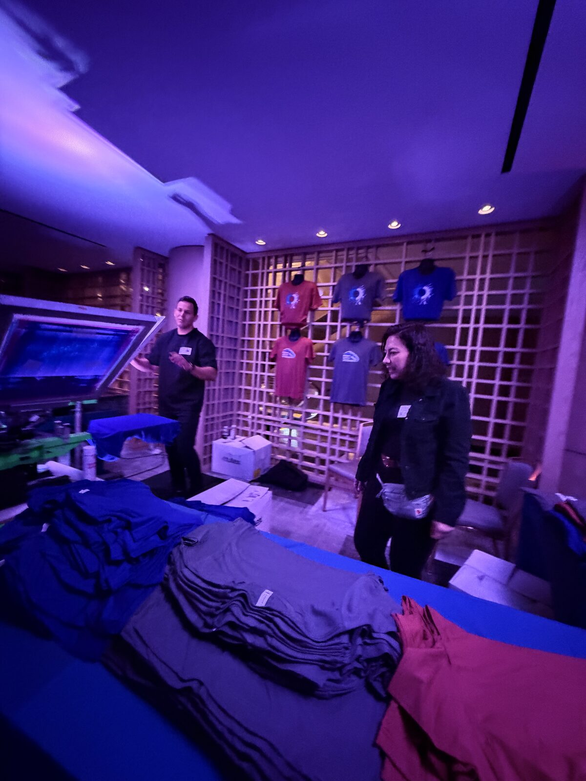 Curated display of finished garments on an evening merch table